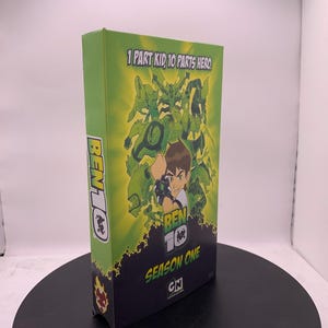 May include: A green Ben 10 Season One DVD box set. The box features the show's logo and characters, with the text "1 PART KID, 10 PARTS HERO". The Cartoon Network logo is also visible.