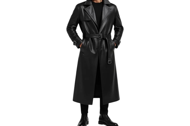May include: A long, black leather trench coat with a belted waist and notched lapels. The coat is knee-length and has a classic trench coat design. The model is wearing black pants and boots.