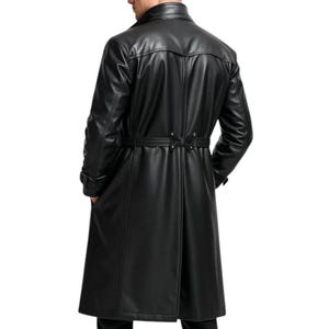 May include: A long, black leather trench coat with a belted waist and a classic collar. The coat has a tailored fit and is designed to reach the ankles. The image shows the back of the coat, highlighting its sleek design and details.