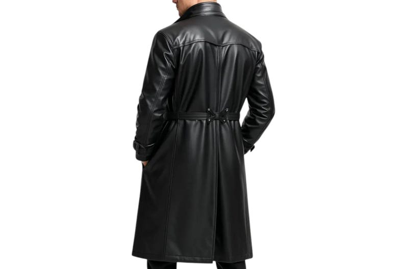 May include: A long, black leather trench coat with a belted waist and a classic collar. The coat has a tailored fit and is designed to reach the ankles. The image shows the back of the coat, highlighting its sleek design and details.