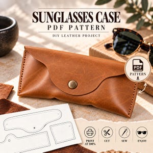 May include: A tan leather sunglasses case with a curved flap and a brass snap button closure. The image includes a white paper template with black outlines for cutting and sewing, along with text reading SUNGLASSES CASE PDF PATTERN.