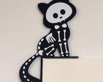 Skeleton cat on the doorpost