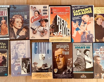 May include: A collection of 15 VHS tapes featuring classic films such as "Giant", "Ben-Hur", "Casablanca", "Captain's Paradise", "Roman Holiday", "Adam's Rib", "Going My Way", "Bells of St. Mary's", "The Magic of Bing Crosby", "Strangers on a Train", "Indiscreet", "The Last Episodes of Victor Borge", "Minniever", and "The Last Episodes of Victor Borge".