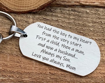 May include: A silver-toned metal dog tag keychain featuring a lobster clasp and a split ring. The tag is engraved with the text: You had the key to my heart from the very start. First a child, then a man, and now a husband... Always my Son. Love you always, Mom.