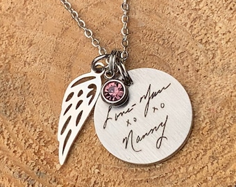 May include: Silver necklace with a small pink crystal, a wing charm, and a round pendant with the inscription "Love - never + to Mommy".