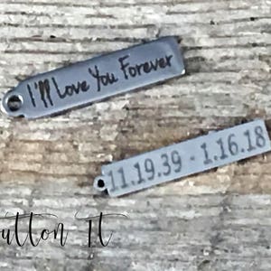 May include: Two silver metal tags with engraved text. The first tag reads "I'm Love You Forever". The second tag reads "11.19.39 - 1.16.18".