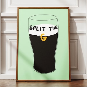 May include: A framed illustration of a pint glass of Guinness with the text "SPLIT THE G" on the foam.