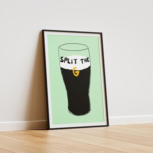 May include: A framed print of a black and white illustration of a glass of Guinness with the text "Split the G" on the foam.