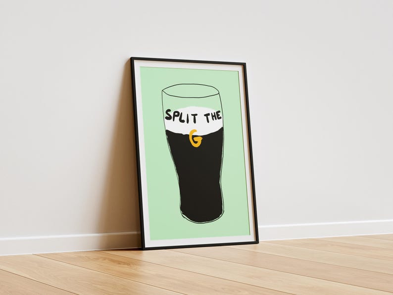 May include: A framed print of a black and white illustration of a glass of Guinness with the text "Split the G" on the foam.