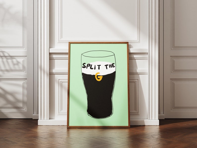 May include: A framed illustration of a pint glass of Guinness with the text "SPLIT THE G" on the foam.