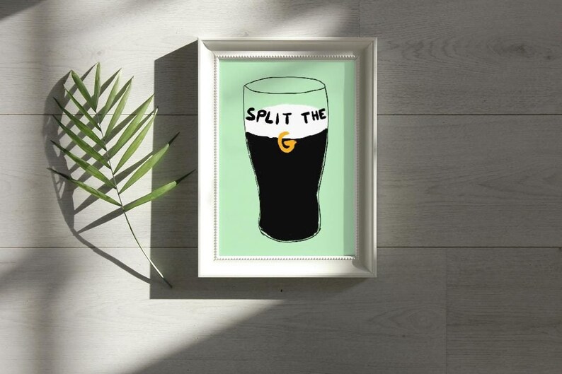 May include: A framed print of a black and white illustration of a pint glass of Guinness with the text "Split the G" on the foam.