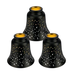May include: A set of three bell-shaped lamp shades featuring a matte black exterior finish with numerous small, scattered cutouts that reveal a bright gold interior lining, creating a speckled light effect across the surface of each shade.