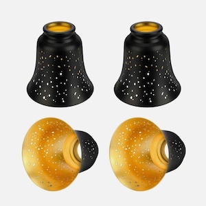 May include: A set of four bell-shaped lamp shades featuring a matte black exterior with small, scattered cutouts that reveal a metallic gold interior lining. The shades have a wide, flared opening at the bottom and a smaller circular opening at the top.