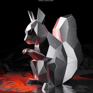 May include: A geometric, metallic squirrel sculpture with a faceted design. The artwork is set against a dark background with red and black accents. The text "SQUIRREL" is at the top left. The finished sculpture size is 700x720x360.