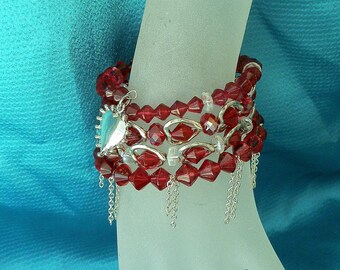 Memory wire cuff  bracelet. Ruby Red crystal beads,silver dangle chains. floating silver hearts, solid silver heart. Pendant. Gift for Her