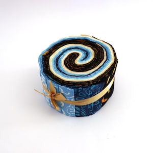 Può includere: Un rotolo di tessuto in tonalità di blu, nero e crema, legato con un nastro dorato. Il tessuto è disposto a spirale, creando un design visivamente accattivante.