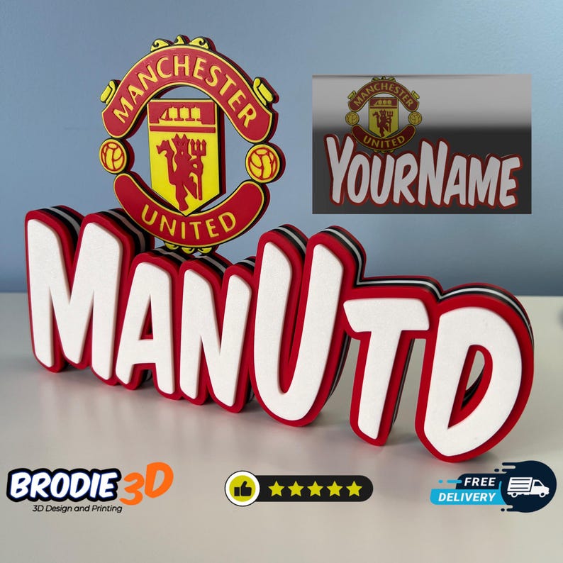 May include: A 3D printed name sign with the word "MANUTD" in red and white letters. The letters are layered and have a black outline. The Manchester United crest is in the background.