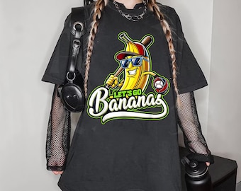 May include: Black t-shirt with a cartoon banana wearing sunglasses and holding a baseball bat. The banana is wearing a baseball cap and the text "Let's Go Bananas" is printed below the banana.