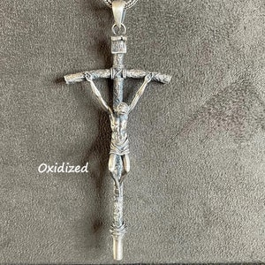 May include: Oxidized silver pendant necklace featuring a detailed crucifix with a figure of Jesus Christ.