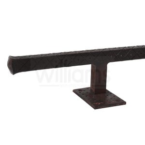 May include: A dark brown metal door handle with a diamond pattern and a square base.