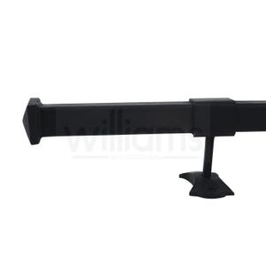 May include: Black metal curtain rod with square ends and a decorative bracket. The rod is designed for use with curtains or drapes.