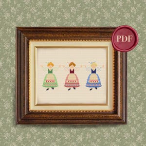 May include: Cross stitch pattern featuring three girls in traditional folk costumes, each wearing a different colored dress with a white apron and a red, white, and blue patterned skirt. The girls are smiling and holding hands.