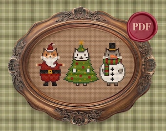 May include: Cross stitch pattern featuring three cats dressed as Christmas characters. A cat dressed as Santa Claus, a cat dressed as a Christmas tree, and a cat dressed as a snowman. The pattern is in a brown oval frame.