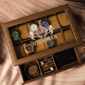 May include: A wooden watch box with a glass top and a drawer. The box has 10 compartments for watches and a drawer for other accessories. The box is personalized with the name "WIERMAN" and a monogram.
