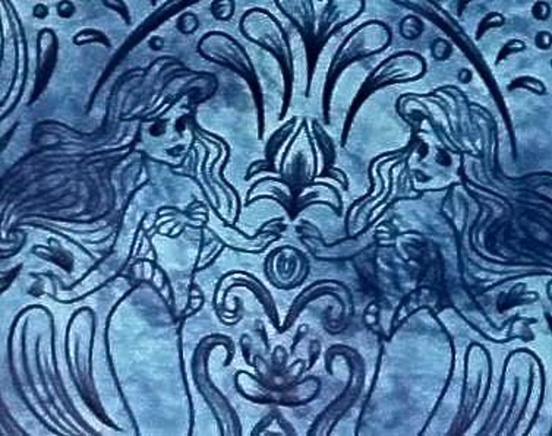 May include: A blue illustration featuring two mermaids facing each other, their hands almost touching. The artwork has a symmetrical design with floral and water-like elements, creating a whimsical and aquatic theme.