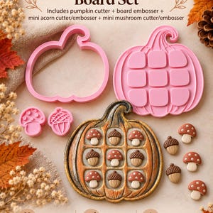 May include: A Pumpkin Tic-Tac-Toe Board Set including a pink pumpkin cutter, a pumpkin board embosser, a mini acorn cutter, and a mini mushroom cutter. A finished pumpkin-shaped game board features small mushroom and acorn game pieces.