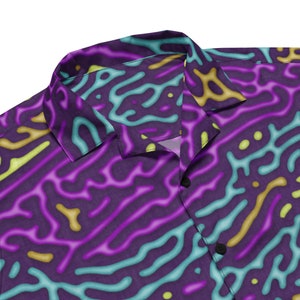 May include: A purple, blue, and yellow patterned button-up shirt with a collar.
