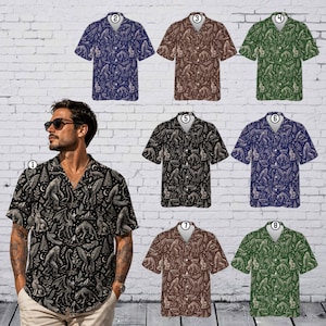 May include: A short-sleeve button-down shirt featuring a repeating pattern of cryptids, including Bigfoot, jackalopes, and mothmen, interspersed with pine trees and crescent moons. The shirt is available in black, blue, brown, and green colorways.