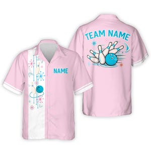 May include: Pink bowling shirt with a retro design. The shirt features a bowling ball and pins graphic on the back and front. The front has a white stripe with bowling pin and starburst designs. The shirt has the word "NAME" on the front.
