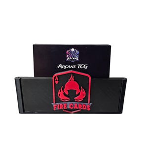 May include: Black card storage box with a red and black design. The box features the text "Arcane TCG" and "Fire Cards". The Fire Cards logo is a red design of a helmet and flames. The box is designed to hold trading cards.