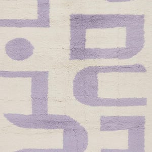 May include: A cream-colored rug with a repeating geometric pattern in lavender. The design features a series of connected shapes, including squares, rectangles, and a circle, creating a modern, abstract aesthetic. The rug has a soft, textured appearance.