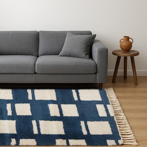 Moroccan wool runner rug featuring a cream square grid pattern on a deep navy blue background, handknotted by Berber artisans. This premium-quality wool rug offers a modern aesthetic with traditional craftsmanship, perfect for entryways, hallways, or kitchens. Its clean geometry, plush texture, and bold contrast make it ideal for contemporary, bohemian, or minimalist spaces seeking authentic Moroccan floor decor with structure and softness.
