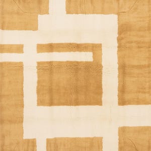 May include: A rectangular rug with a geometric design. The rug features a pattern of intersecting white lines against a tan background. The rug's texture appears soft and plush, with a subtle variation in color.