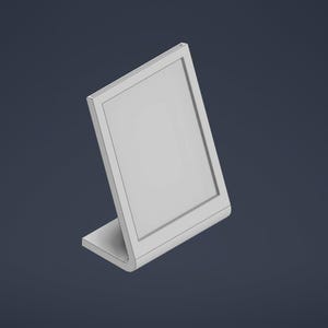 May include: A white picture frame with a stand, angled to the right. The frame is empty.
