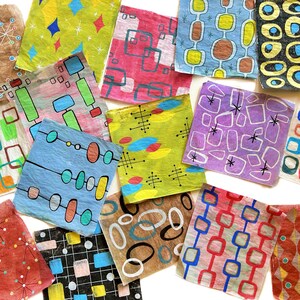 May include: A selection of square decorative papers with retro designs. The papers display a variety of patterns, including geometric shapes and atomic-age motifs. The colour palette includes red, blue, green, and yellow, evoking a mid-century modern aesthetic.