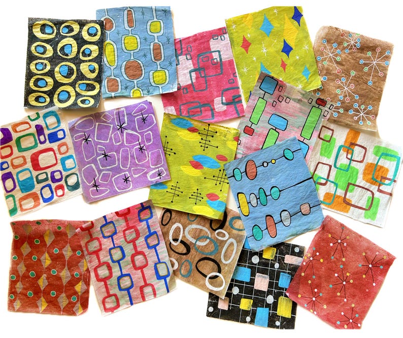 May include: A selection of square art pieces with mid-century modern designs. Each piece displays unique patterns with geometric shapes, lines, and dots in various colours, including blue, red, green, and yellow. The art pieces are arranged on a white surface.