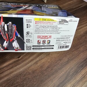 May include: A box for a RG 1/144 ZETA GUNDAM plastic model kit. The box features a detailed image of the assembled model, showcasing its red, white, blue, and gray color scheme. The box also includes Japanese text and warnings.