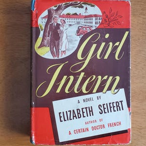 May include: Vintage book cover for "Girl Intern" by Elizabeth Seifert. The cover features a couple walking near a building and a red car. The title is in yellow script, with the author's name in a white rectangle.