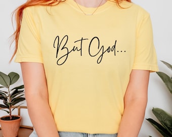 May include: A yellow t-shirt with the text "But God..." in black script.