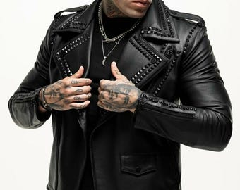 Könnte beinhalten: Eine schwarze Lederjacke mit Reißverschluss und Nietenbesatz. Die Jacke hat einen Kragen und zwei Taschen.