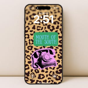 May include: Smartphone screen displaying a leopard print background with a pink rotary phone graphic and the text "MOUTH OF THE SOUTH" in a green speech bubble. The time is 2:51 PM on Sunday, December 21.