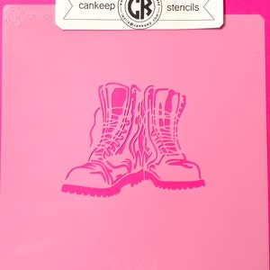 May include: A pink plastic stencil of two boots with laces. The stencil is 2.5 inches by 3 inches. The stencil is for crafting and decorating.