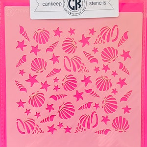May include: A pink plastic stencil with a repeating pattern of seashells and starfish. The stencil is designed for crafting and decorating projects. The text "cankeep stencils" is printed at the top of the stencil.