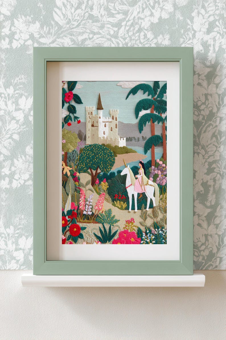 May include: Embroidered artwork in a green frame depicts a fairytale scene. A woman rides a white unicorn through a colorful garden, with a castle in the background. The artwork is filled with vibrant flowers and lush greenery.