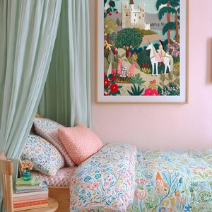 May include: A bedroom scene featuring a wooden bed with floral bedding and pillows. A framed tapestry depicts a castle scene with a unicorn. A light green canopy hangs above the bed, and a small wooden chair holds books and a vase of flowers. The walls are painted pink.