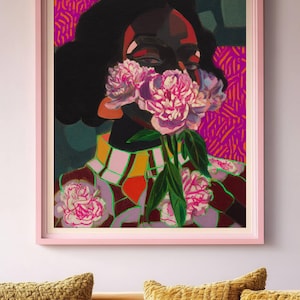 May include: A framed art print featuring a stylized portrait of a person with dark skin, obscured by a cluster of pink peonies. The background displays vibrant magenta and orange patterns, while the person wears a checkered collar and floral garment.